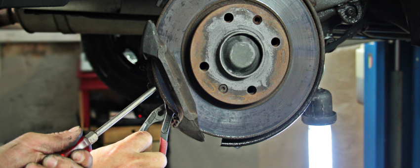 Close up of someone repairing a brake disc